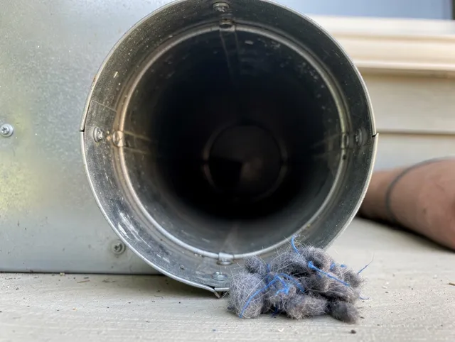 Aurora Dryer Vent Cleaning technician using specialized equipment to clear severe dryer vent blockage in Aurora